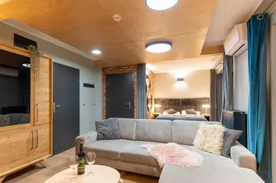 a living room with a couch and a bed at H&G Boutique Apartments in Oświęcim