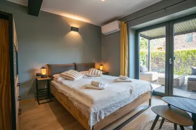 a bedroom with a bed and a large window at H&G Boutique Apartments in Oświęcim