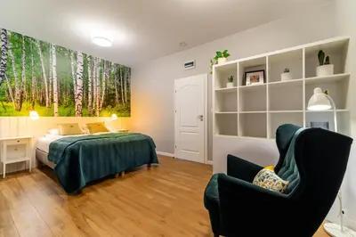 a bedroom with a bed and a chair at Apartamenty Black Lion in Pcim