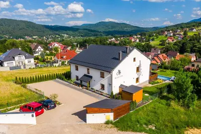 an aerial view of a small town with a white house at Apartamenty Black Lion in Pcim