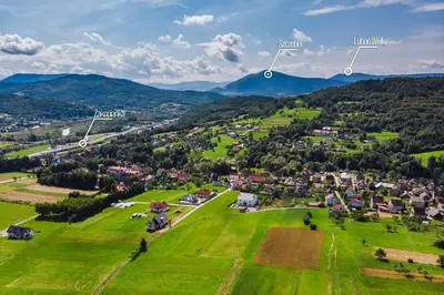 an aerial view of a small village in a green field at Apartamenty Black Lion in Pcim