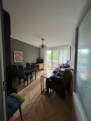 a living room with a couch and a dining room at u cioci Lutki urocze mieszkanie z balkonem in Kraków