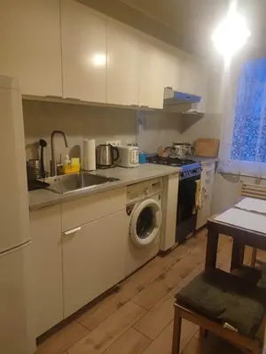 a kitchen with a sink and a washing machine at u cioci Lutki urocze mieszkanie z balkonem in Kraków