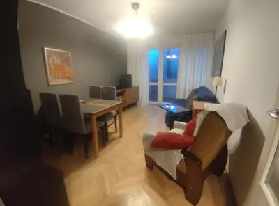 a living room with a table and a dining room at u cioci Lutki urocze mieszkanie z balkonem in Kraków