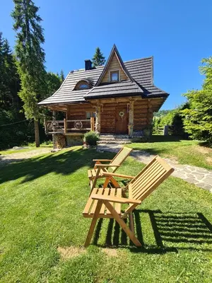 a small log cabin with a black roof at Bacówka Polanki in Obidowa
