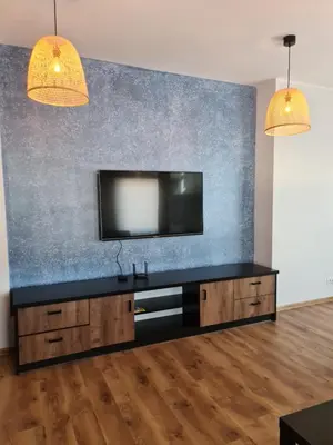 a living room with a flat screen tv on a wall at Apartament Limanowa Rynek in Limanowa