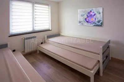 a room with a bed and a window at Apartament Izabel in Nowy Targ