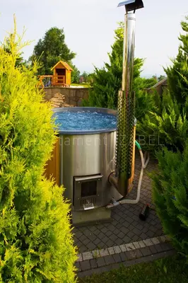 a swimming pool with a hot tub in a garden at Apartament Izabel in Nowy Targ