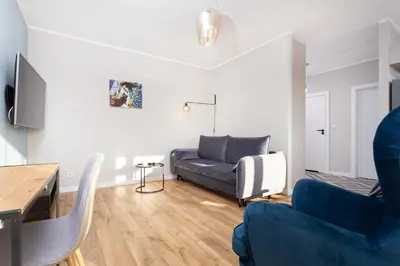 a living room with a couch and two chairs at City of the Kings - Indigo Apartment in Kraków