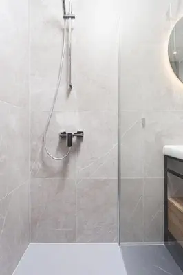 a shower with a glass door in a bathroom at City of the Kings - Indigo Apartment in Kraków