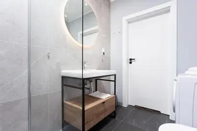 a bathroom with a sink and a mirror at City of the Kings - Indigo Apartment in Kraków