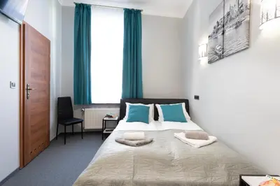 a bedroom with a bed with two pillows on it at DAVE Elegant Apartments KRAKÓW Old Town in Kraków