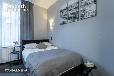 a bedroom with a bed and a window at SMOOTH Elegant Apartments KRAKÓW Old Town in Kraków