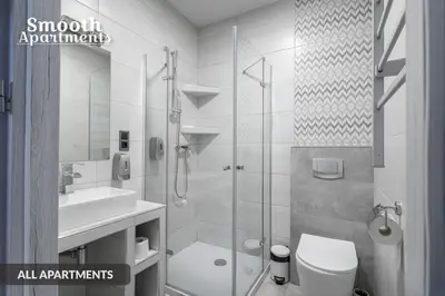 a bathroom with a shower and a toilet and a sink at SMOOTH Elegant Apartments KRAKÓW Old Town in Kraków