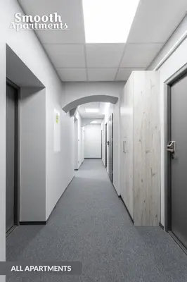 an empty hallway in an office building with white walls at SMOOTH Elegant Apartments KRAKÓW Old Town in Kraków