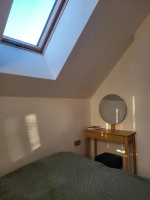 a bedroom with a bed and a skylight at Slow Life Rabka in Rabka
