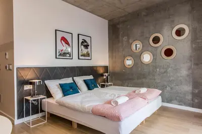 a bedroom with a large bed and a large window at Piedmont House in Kraków