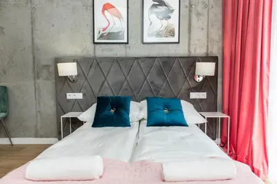 a bedroom with a bed and a room with a table at Piedmont House in Kraków