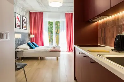 a white bathroom with a shower and a sink at Piedmont House in Kraków