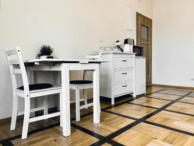 a kitchen with a white desk and two chairs at Apartament Moments Stare Miasto Style and Comfort Netflix in Kraków
