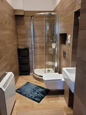 a bathroom with a shower and a toilet and sink at Apartament Moments Stare Miasto Style and Comfort Netflix in Kraków