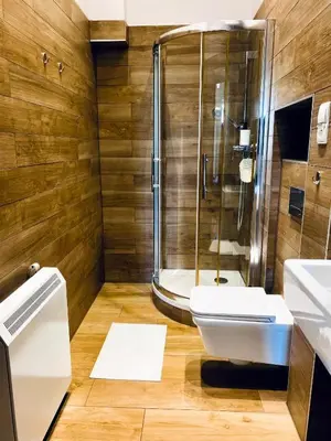 a bathroom with a shower and a toilet and a sink at Apartament Moments Stare Miasto Style and Comfort Netflix in Kraków