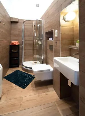 a bathroom with a toilet and a sink and a shower at Apartament Moments Stare Miasto Style and Comfort Netflix in Kraków