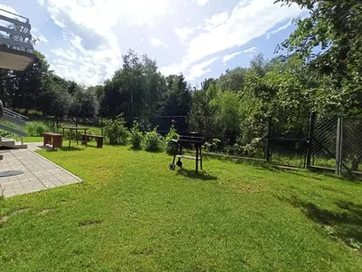 a garden with a cart in the grass at Feel like in Heaven in Bachowice