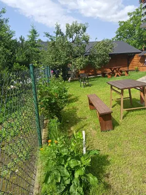 a picnic table and a bench in a yard at Feel like in Heaven in Bachowice