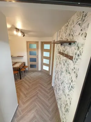 a hallway with a dining room and a table at Feel like in Heaven in Bachowice