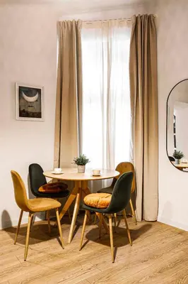 a table and chairs in a room with a window at Charming Apartment, Wawel & Old Town Krakow in Kraków