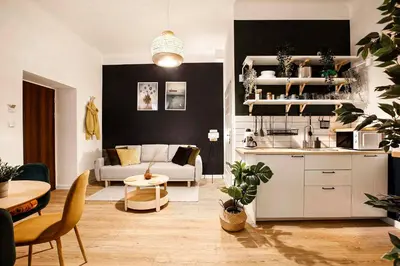 a kitchen and living room with a couch and a table at Charming Apartment, Wawel & Old Town Krakow in Kraków
