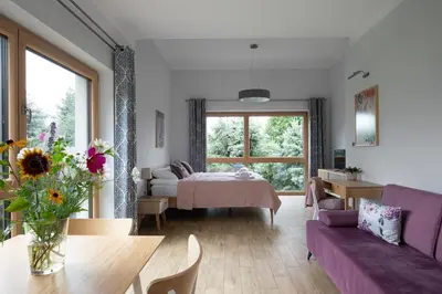 a living room with a bed and a table at Dębowy Zakątek - SPOKOJNY, KOMFORTOWY WYPOCZYNEK W OKOLICY KRAKOWA in Radziszów
