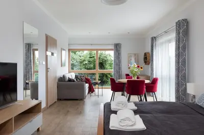 a living room with a bed and a dining room at Dębowy Zakątek - SPOKOJNY, KOMFORTOWY WYPOCZYNEK W OKOLICY KRAKOWA in Radziszów