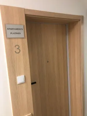 a wooden door with a sign on it at Apartamenty Platinex 4 in Kraków