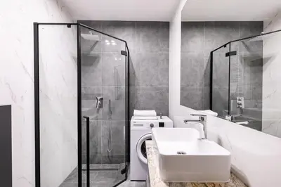 a bathroom with a toilet and a sink and a shower at Apartamenty Platinex 4 in Kraków