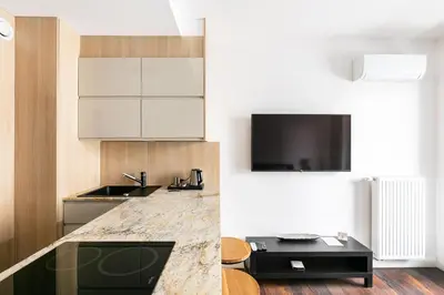 a kitchen with white cabinets and a counter top at Apartamenty Platinex 4 in Kraków