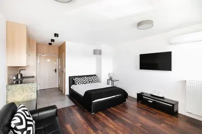 a living room with a bed and a couch at Apartamenty Platinex 5 in Kraków