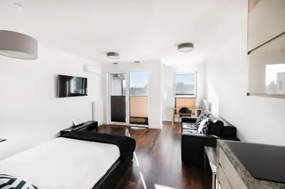 a bedroom with a bed and a couch at Apartamenty Platinex 5 in Kraków
