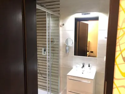 a bathroom with a shower and a sink and a mirror at Zajazd Podzamcze in Olkusz