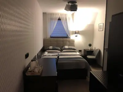 a small bedroom with a bed and a window at Zajazd Podzamcze in Olkusz