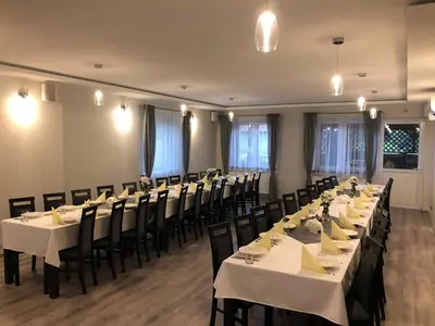 a conference room with tables and chairs in it at Zajazd Podzamcze in Olkusz