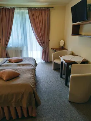 a hotel room with two beds and a window at ZAGÓRZANKA Pensjonat Rehabilitacyjno-Rekreacyjny SiS Dziadkowiec - Spółka Jawna in Mszana Dolna