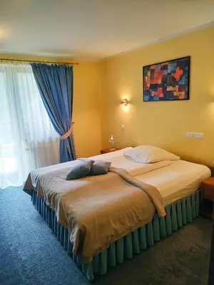 a large bed in a room with a window at ZAGÓRZANKA Pensjonat Rehabilitacyjno-Rekreacyjny SiS Dziadkowiec - Spółka Jawna in Mszana Dolna