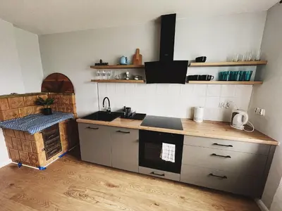 a kitchen with a sink and a stove top oven at Apartamenty Pod Kątami in Kamienica