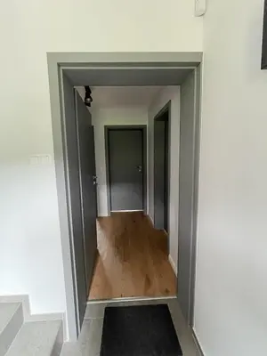 a hallway in a house with wood floors at Apartamenty Pod Kątami in Kamienica