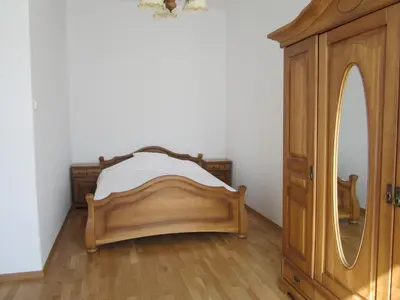 a bedroom with a bed and a dresser and a mirror at Apartment Świetego Tomasza in Kraków