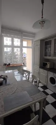a kitchen with a table and chairs in a room at Apartment Świetego Tomasza in Kraków