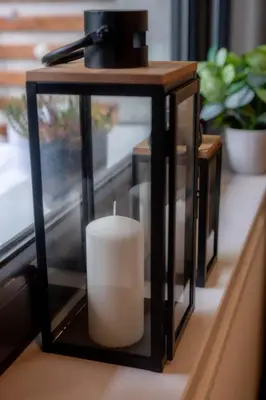 a candle in a glass holder on a table at Smart Executive in Kraków