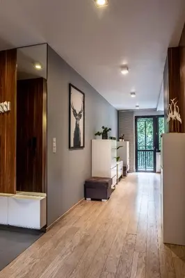 an empty room with a hallway with wood flooring at Smart Executive in Kraków